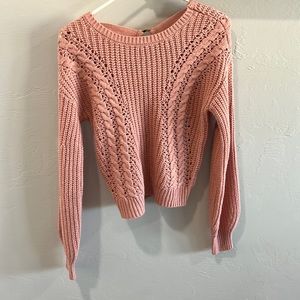 Cute pink, kinda cropped sweater, with a little of the back showing